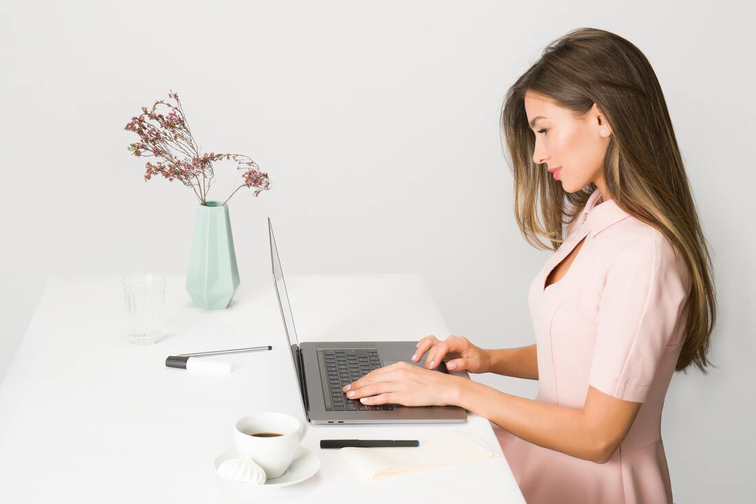 Woman in pink dress using laptop computer - photo by Moose Photos from Pexels